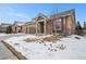 Exterior elevation of a home featuring a two-car garage, stone accents, and a welcoming front porch at 160 Pipit Lake Way, Erie, CO 80516