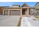 Charming home featuring a two-car garage, stone accents, and a welcoming front porch at 160 Pipit Lake Way, Erie, CO 80516