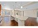 Open kitchen and dining area featuring granite countertops and hardwood floors at 160 Pipit Lake Way, Erie, CO 80516