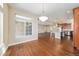 Living room with hardwood floors, a large window, and a view into the kitchen at 160 Pipit Lake Way, Erie, CO 80516