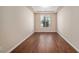 Clean, bright room featuring hardwood floors, neutral walls, and a modern tray ceiling at 160 Pipit Lake Way, Erie, CO 80516