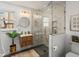 Modern bathroom features a glass enclosed shower, a floating wood vanity, and gold finishes at 1640 E Virginia Ave, Denver, CO 80209