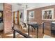 Open dining area with exposed brick walls, wood floors, modern lighting, and a stylish dining table set at 1640 E Virginia Ave, Denver, CO 80209