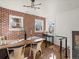 Bright dining area with hardwood floors, brick accent wall, and stylish decor at 1640 E Virginia Ave, Denver, CO 80209