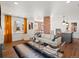 Sunlit living room featuring hardwood floors, modern furniture, and seamless open floor plan design at 1640 E Virginia Ave, Denver, CO 80209