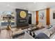 Stylish living room featuring a modern fireplace, hardwood floors, and large windows for natural light at 1640 E Virginia Ave, Denver, CO 80209