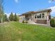 Expansive backyard with lush lawn and stone patio, great for entertaining and outdoor enjoyment at 19379 W 57Th Pl, Golden, CO 80403