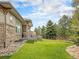Spacious backyard with lush lawn, privacy fence and covered patio area for comfortable outdoor living at 19379 W 57Th Pl, Golden, CO 80403