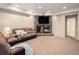 Cozy basement living area features a stone fireplace with a large television and comfortable seating at 19379 W 57Th Pl, Golden, CO 80403