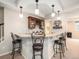 Stylish basement bar with granite countertops, dark wood cabinets, and seating for entertaining at 19379 W 57Th Pl, Golden, CO 80403