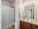 Simple bathroom with a shower/tub combo and vanity with a sink and framed mirror at 19379 W 57Th Pl, Golden, CO 80403