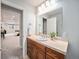 Bathroom with wood vanity and decorative plant at 19379 W 57Th Pl, Golden, CO 80403