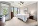 Bright bedroom with a ceiling fan, and access to outdoor balcony at 19379 W 57Th Pl, Golden, CO 80403