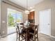 Breakfast nook with dark wood table and chairs; sliding glass doors lead to outdoor patio at 19379 W 57Th Pl, Golden, CO 80403