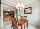 Dining area featuring a chandelier, wood table, and view into the kitchen at 19379 W 57Th Pl, Golden, CO 80403