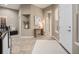 Inviting foyer with neutral walls, decorative niche, tile floors, and a view into other rooms at 19379 W 57Th Pl, Golden, CO 80403