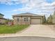 Charming single Gathering home with beautiful stone accents, a well-manicured lawn and a two car garage at 19379 W 57Th Pl, Golden, CO 80403