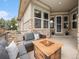Inviting covered front porch features a cozy seating area and stone accents, creating a welcoming entrance at 19379 W 57Th Pl, Golden, CO 80403