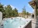 Inviting backyard hot tub with privacy fence and stone patio perfect for outdoor relaxation at 19379 W 57Th Pl, Golden, CO 80403