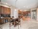 Open-concept kitchen with wood cabinets and island, adjacent to breakfast nook and stainless appliances at 19379 W 57Th Pl, Golden, CO 80403