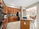 Kitchen with dark wood cabinetry, granite countertops, stainless steel appliances, and island at 19379 W 57Th Pl, Golden, CO 80403
