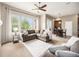 Spacious living room with large windows, a ceiling fan, and a view of breakfast nook at 19379 W 57Th Pl, Golden, CO 80403