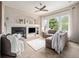 Cozy living room with fireplace, large windows, and neutral-colored furniture at 19379 W 57Th Pl, Golden, CO 80403