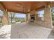 Covered outdoor kitchen with stone fireplace and built-in grill, perfect for alfresco dining and entertaining at 19379 W 57Th Pl, Golden, CO 80403