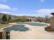 Community pool with winter cover, cabana buildings, and mountain views in a well-maintained setting at 19379 W 57Th Pl, Golden, CO 80403