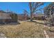 Expansive backyard with a large tree and a covered patio area for outdoor enjoyment at 1120 Holly St, Denver, CO 80220