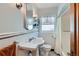 Charming bathroom with tiled walls, classic fixtures, and a window for natural light at 1120 Holly St, Denver, CO 80220