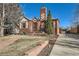 Beautiful brick home featuring a stone walkway, well-maintained landscaping, and a detached garage at 1120 Holly St, Denver, CO 80220