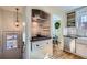 Efficient kitchen layout with modern appliances, white cabinets, and access to the dining area at 1120 Holly St, Denver, CO 80220