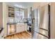 Modern kitchen with stainless steel appliances, white cabinetry, and a stylish farmhouse sink at 1120 Holly St, Denver, CO 80220