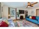 Cozy living room with hardwood floors, a faux fireplace, and comfortable seating with a TV at 1120 Holly St, Denver, CO 80220