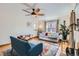 Bright living room with hardwood floors, a ceiling fan, and comfortable seating with natural light at 1120 Holly St, Denver, CO 80220