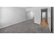 Bedroom with mirrored closet doors, gray carpet, neutral walls, and an en-suite hallway at 1050 S Monaco Pkwy # 68, Denver, CO 80224