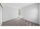 Well-lit bedroom features neutral carpet and a large window; ready for personalization at 1050 S Monaco Pkwy # 68, Denver, CO 80224