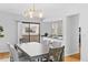 Open dining room flowing into the kitchen with modern lighting and a view at 1050 S Monaco Pkwy # 68, Denver, CO 80224