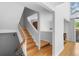 Bright entryway boasts natural light and an open staircase with hardwood floors at 1050 S Monaco Pkwy # 68, Denver, CO 80224