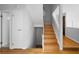 Welcoming foyer with hardwood floors, staircase, and convenient coat closet at 1050 S Monaco Pkwy # 68, Denver, CO 80224