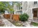 Exterior shot of townhome featuring well-maintained wooden fence and lush greenery at 1050 S Monaco Pkwy # 68, Denver, CO 80224