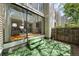Exterior view of a ground-level patio with an artificial lawn and large windows at 1050 S Monaco Pkwy # 68, Denver, CO 80224