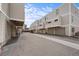 Exterior view of townhome garages and street with neutral siding, offering convenient parking at 1050 S Monaco Pkwy # 68, Denver, CO 80224