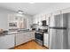 Bright kitchen features stainless steel appliances and granite countertops at 1050 S Monaco Pkwy # 68, Denver, CO 80224
