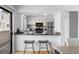 Open-concept kitchen with stainless steel appliances and breakfast bar at 1050 S Monaco Pkwy # 68, Denver, CO 80224