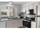The kitchen features stainless steel appliances and a large window for natural light at 1050 S Monaco Pkwy # 68, Denver, CO 80224