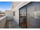 Exterior of patio deck area with sliding glass door, railing, and wood flooring at 1050 S Monaco Pkwy # 68, Denver, CO 80224