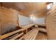 An interior sauna with wooden benches, wall fixtures, and a stone heater at 1050 S Monaco Pkwy # 68, Denver, CO 80224