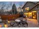 A charming backyard patio featuring outdoor seating, a fire pit, and a stone retaining wall at 2042 S Clayton St, Denver, CO 80210